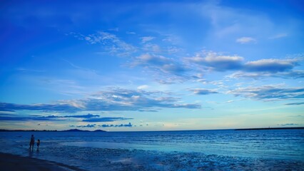 The sky has the light of the sun, the sky is blue, there are small and large clouds alternating and moving slowly, with the sunlight passing, creating a miraculous abstract shape, a hot day.