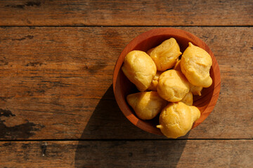 Dry Soes Cake in a small wooden bowl with wooden background