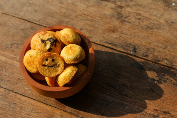 Kue bolu kering or Dried sponge cake in a small wooden bowl with wooden background