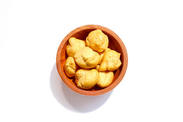 Dry Soes Cake in a small wooden bowl isolated on white background