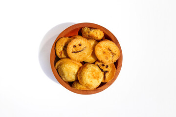 Kue bolu kering or Dried sponge cake in a small wooden bowl isolated on white background

