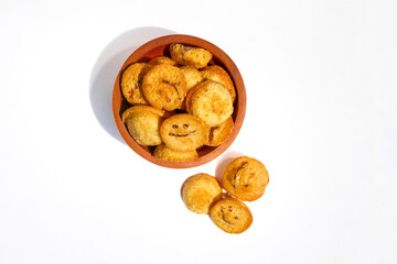Kue bolu kering or Dried sponge cake in a small wooden bowl isolated on white background
