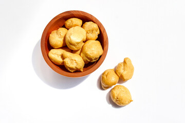 Dry Soes Cake in a small wooden bowl isolated on white background