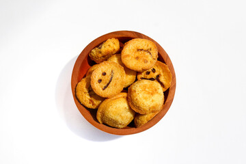 Kue bolu kering or Dried sponge cake in a small wooden bowl isolated on white background
