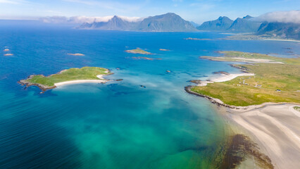 A breathtaking aerial view of a Norwegian archipelago, showcasing the crystal-clear waters, pristine beaches, and lush green islands. Kolbeinsanden Beach, Lofoten