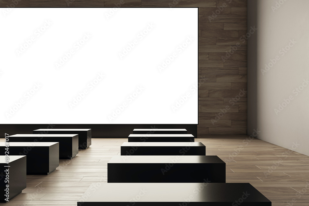 Poster empty cinema hall with large white screen and black seats. 3d rendering