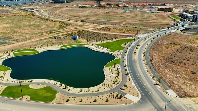 Aerial footage of an artificial lake on Painted Rdg Pkwy near Desert Color neighborhood in Utah, USA