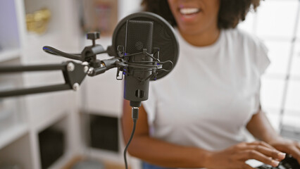 African american woman singing in music studio