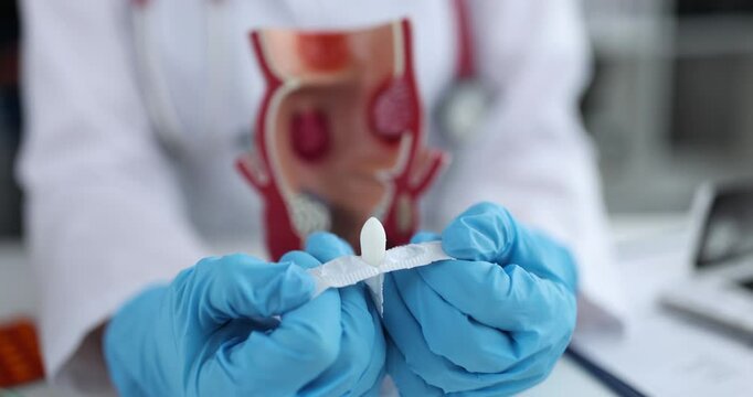 Doctor opens anal medical suppositories for digestive problems. Treatment of hemorrhoids concept