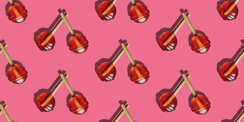 Seamless design of vibrant candy lollipops on  pink background.