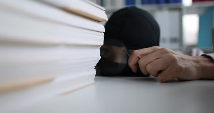 Scammer examines business documents of competitor in office. Corporate espionage concept