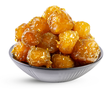 Sweet and sour stir fried soft plum with ginger in a black ceramic bowl