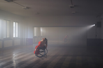 Beautiful dance in a wheelchair of a woman with physical impairment at a dancing studio. Dancesport and disability concept. © 24K-Production