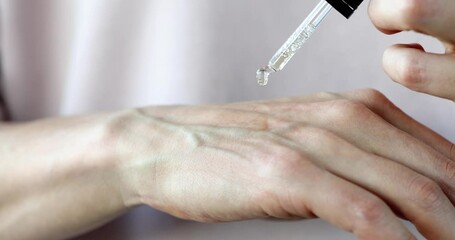 Oil dripping on the hand for moisturizing and skin care. Essential oils for skin rejuvenation concept