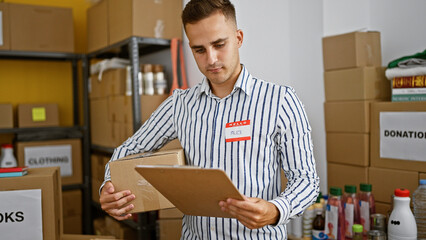 Young man named alex checking inventory in a well-organized warehouse full of donated goods.