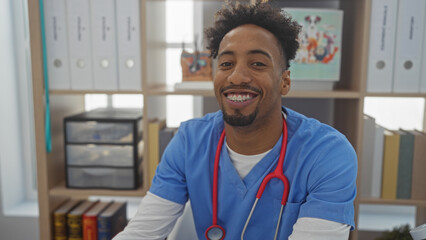 Happy african american man with a beard and stethoscope smiling in a veterinary clinic's interior,...