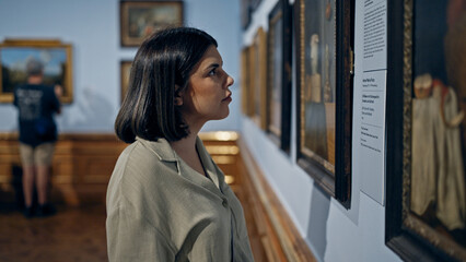Young beautiful hispanic woman visiting art gallery at Belvedere Palace in Vienna
