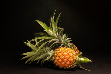yellow pineapple fruit green leaves Healthy natural summer food. Sweet and juicy taste. Isolated on black background.