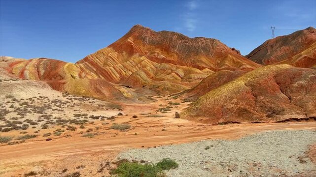 Aerial drone footage of most colorful mountains on earth, the rainbow mountains of Zhangye Danxia National Geological Park. Shown is the most vibrant, multicolored part of this amazing landscape.