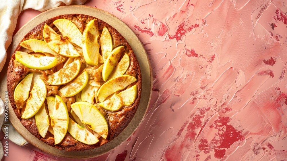 Fototapete rustic spiced apple cake with fresh apple slices on a light red background, cozy and inviting for au