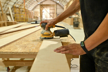 Wood wooden modular houses made of timber yellow board saw processing hands nail grind