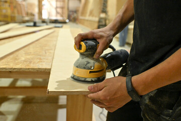 Wood wooden modular houses made of timber yellow board saw processing hands nail grind