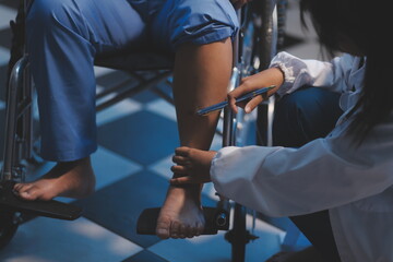 Asian young professional successful friendly female nurse in blue hospital uniform helping supporting physical therapy senior old pensioner unhealthy injury woman patient walking via four legs walker.