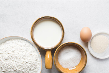 Overhead view of Mise en place of ingredients for making coco bread, ingredients for making jamaican bread on a table, process of making coco bread