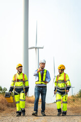 A team of maintenance engineers working on wind farm, team wind turbine experts discussing clean energy production. alternative renewable energy concept © Pituk