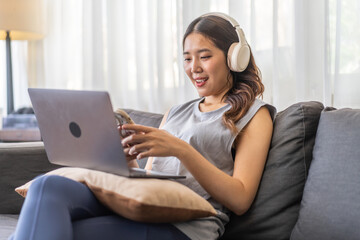 Naklejka premium Young smiling asian woman happy relax use laptop conference work,learning, education, shopping, study online, webinar, online marketing, business, blog, digital internet advertising at home