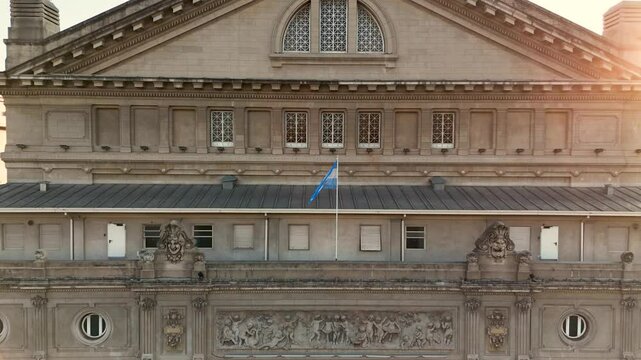 Front of the Colon Theater in Buenos Aires, Argentina. Front still aerial camera takes in the facade with Argentine flag