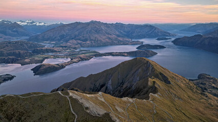 Aerial view over the summit of Roys peak looking over lake Wanaka and the surrounding mountains. A...