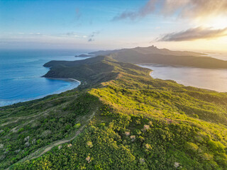 Aerial view of tropical islands in Fiji at sunrise. Remote untouched dense forest covers the long thin pacific. Yasawa Islands, Fiji. 
