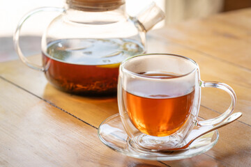 Warm Glass Teapot with Freshly Brewed Tea on Wooden Table - Cozy Beverage Moment