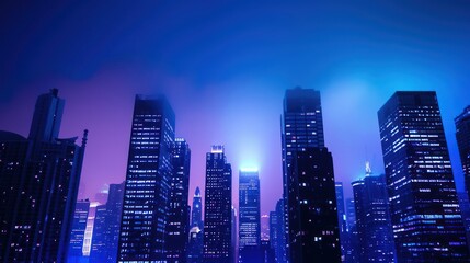 Obraz premium Spectacular view of a high-rise building glowing in the dark against urban backdrop.