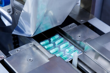 capsule pill ready on medicine aluminum foil packaging in the process of packing at automatic...