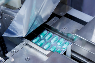 capsule pill ready on medicine aluminum foil packaging in the process of packing at automatic...