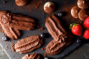 Chocolate shortbread cookies. Dark background.