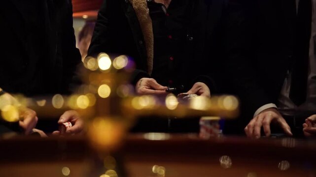 Close Up of Hands Playing Casino Game at Night