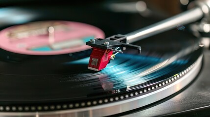 A record player is playing a record with a stylus on it. The stylus is black and silver