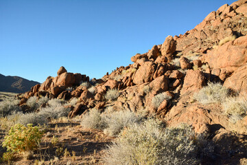 Fototapeta premium The stony foot of the mountain is strewn with large stones. Desert hot arid landscape. Drought and dehydration of the planet