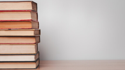 Old books on a wooden shelf.