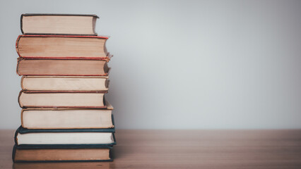 Old books on a wooden shelf.
