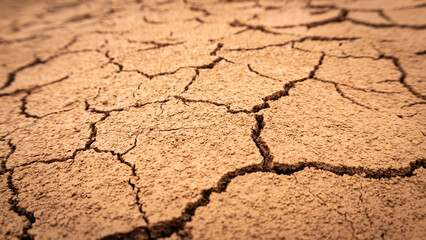 Texture of cracked ground, the dried earth with clay and sand, dry mud, broken texture. Concept of drought and global warming.