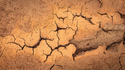 Texture of cracked ground, the dried earth with clay and sand, dry mud, broken texture. Concept of drought and global warming.