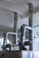 Internal air duct at the enterprise in the workshop with electric air pumps. vertical frame