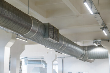 Air duct pipes at the factory in the workshop with dampers for air