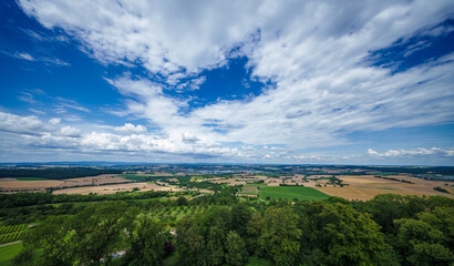 Enjoy the Beautiful Scenery of a Vineyard and Village set against a Dramatic Sky