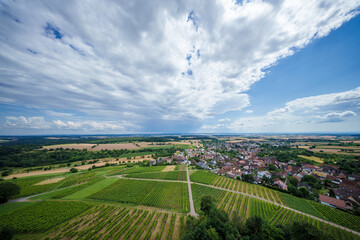 Enjoy the Beautiful Scenery of a Vineyard and Village set against a Dramatic Sky