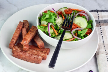 fresh garden salad with a side of fries